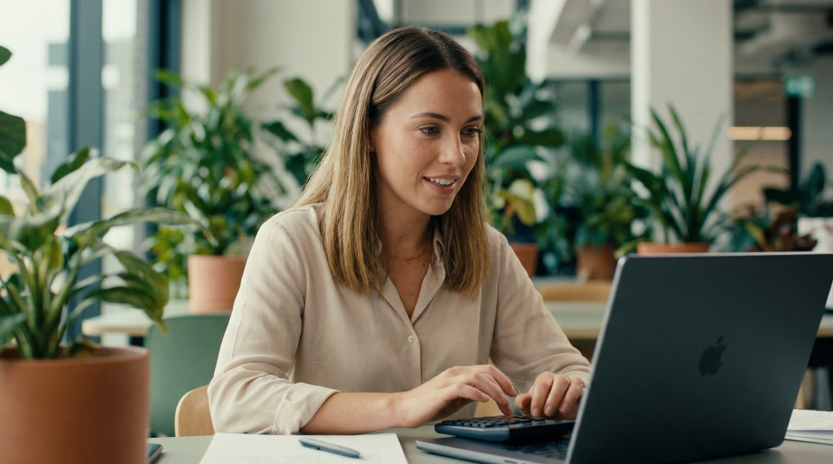 A business owner working on her laptop managing finances with RUUT